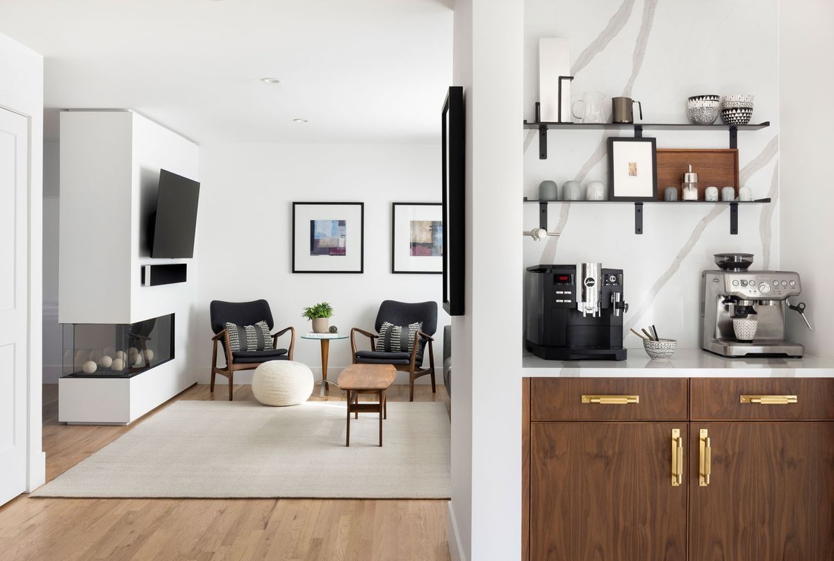 A living room with a coffee maker and a coffee station