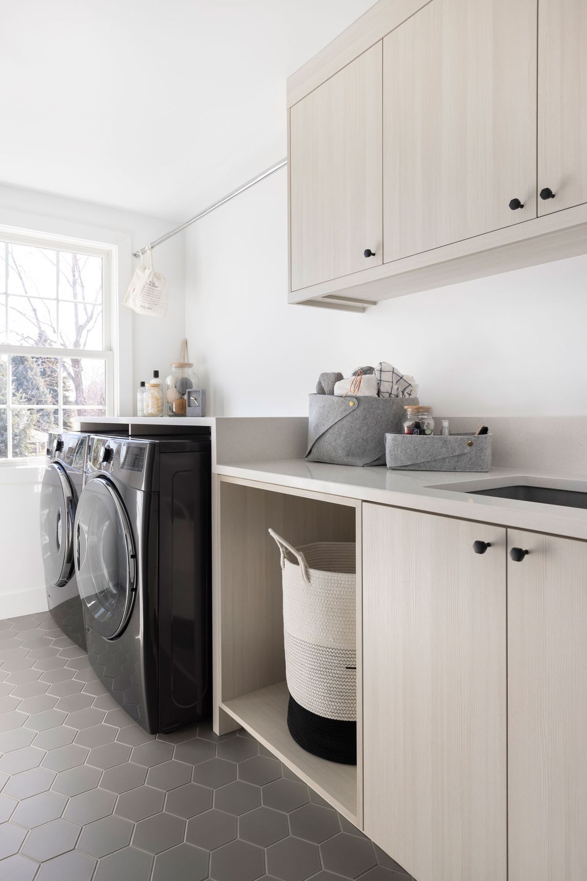 A laundry room with a washer and dryer and a sink.