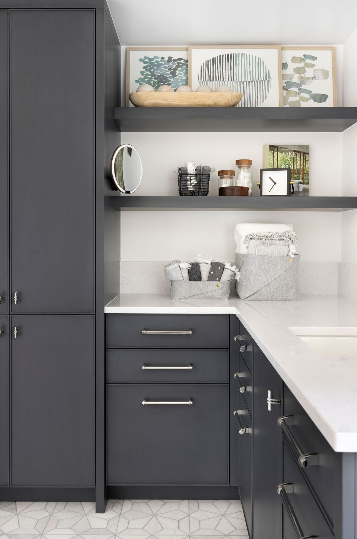 A mud room with a bench, hooks, and a basket.