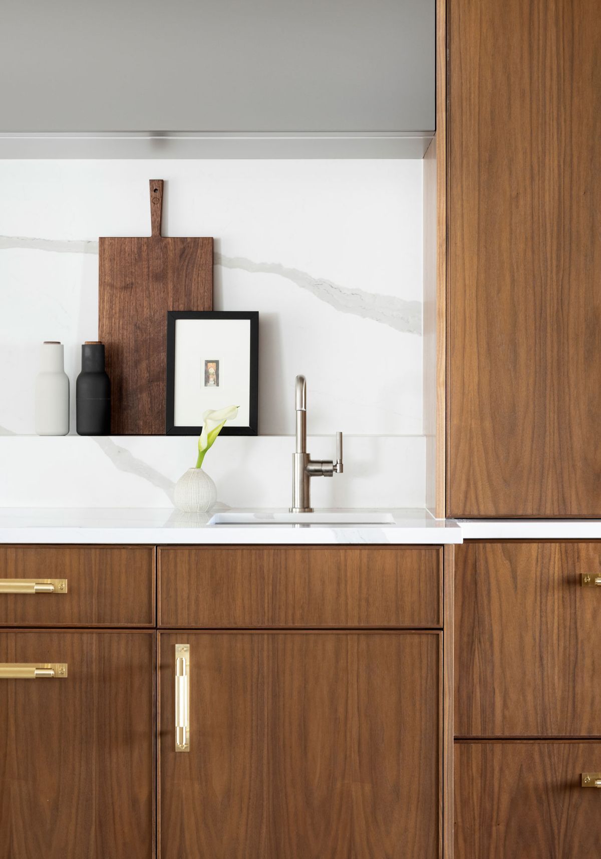 A kitchen with wooden cabinets and a sink.