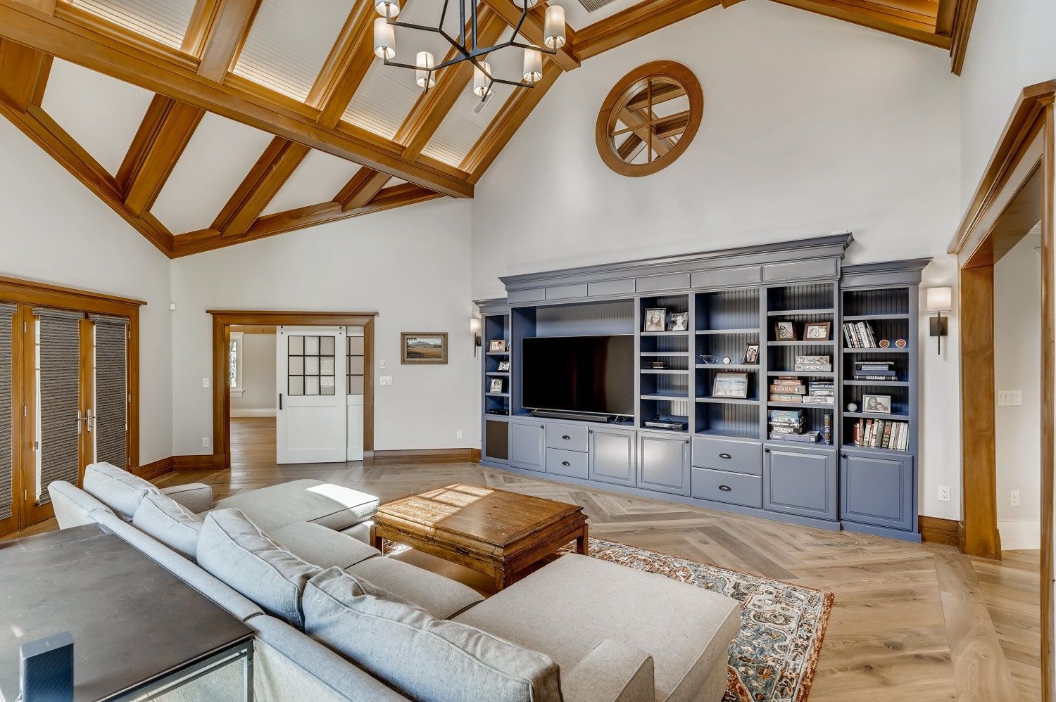 A living room with a couch, coffee table, and television.