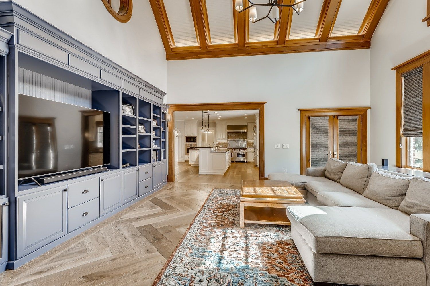 A living room with a couch, television, and entertainment center.