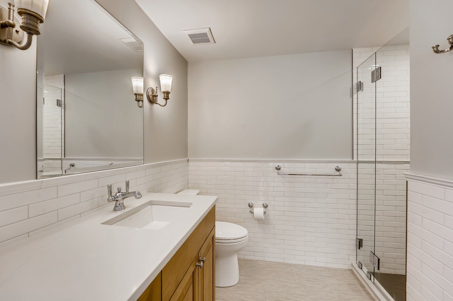 A bathroom with a walk in shower and a door.