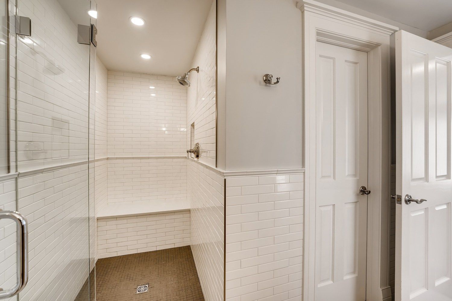 A bathroom with a tub, sink, and mirror.