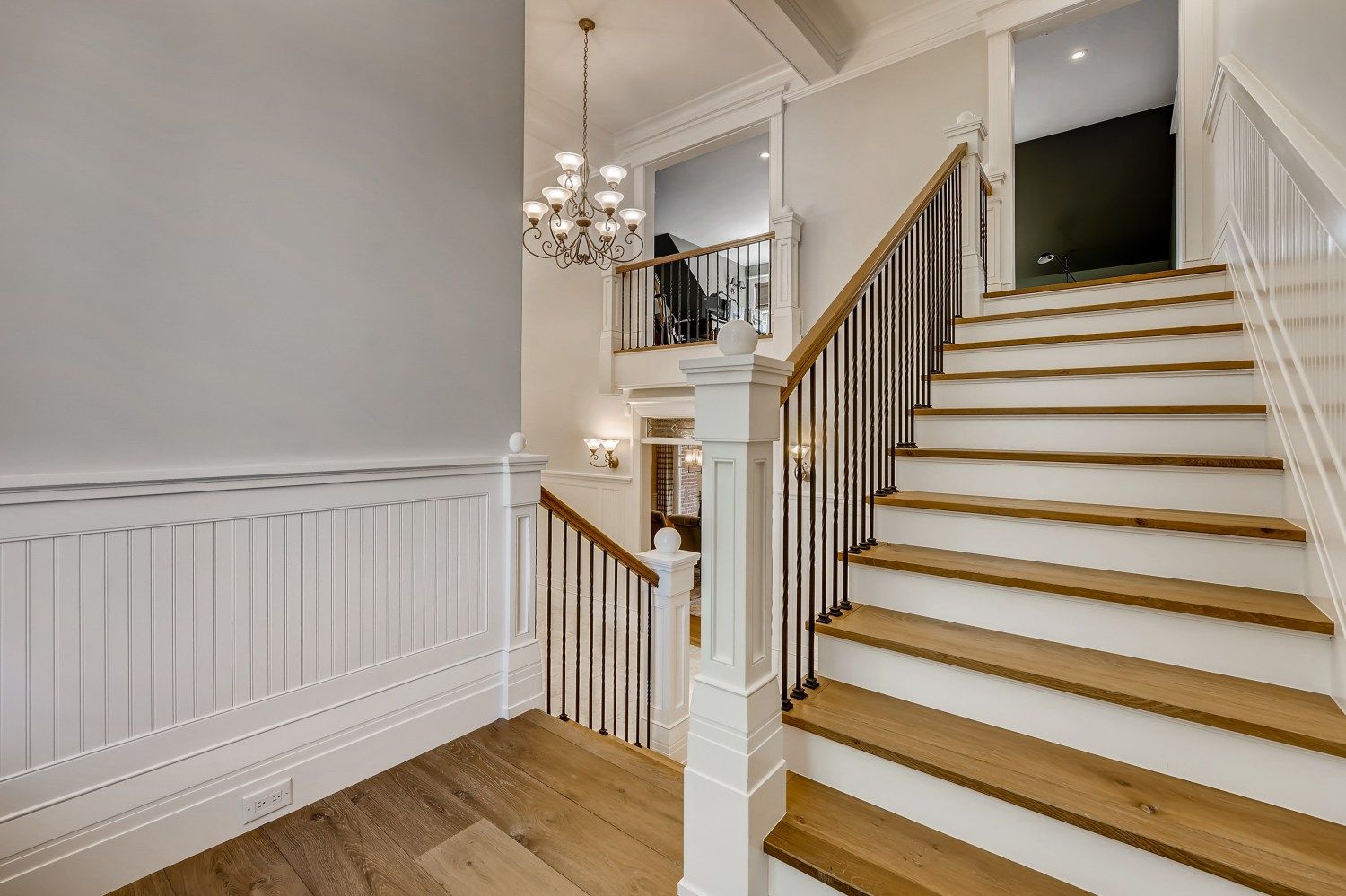 A staircase with white steps and wooden steps in a house.