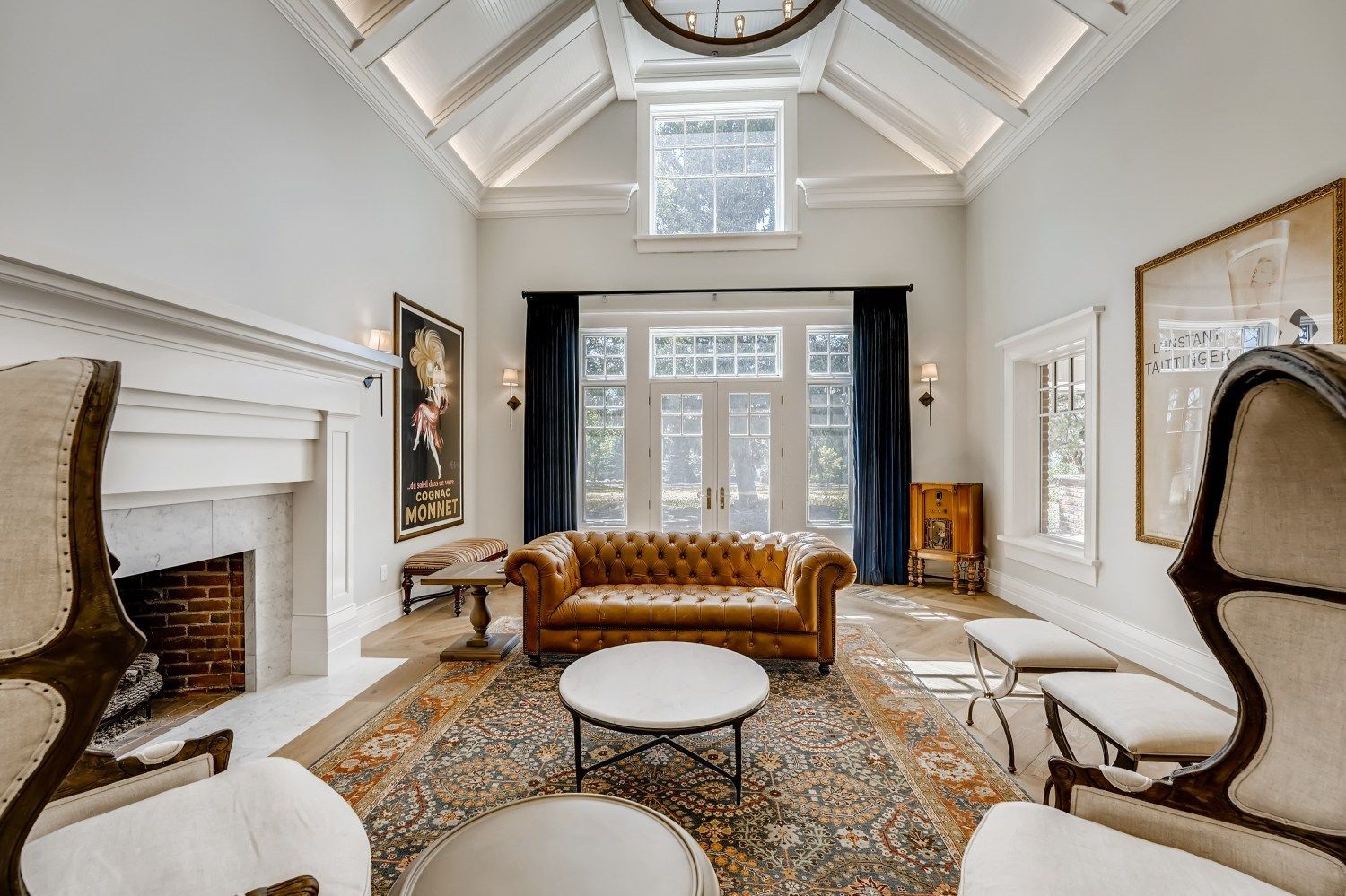 A living room with a couch, chairs, and a fireplace.