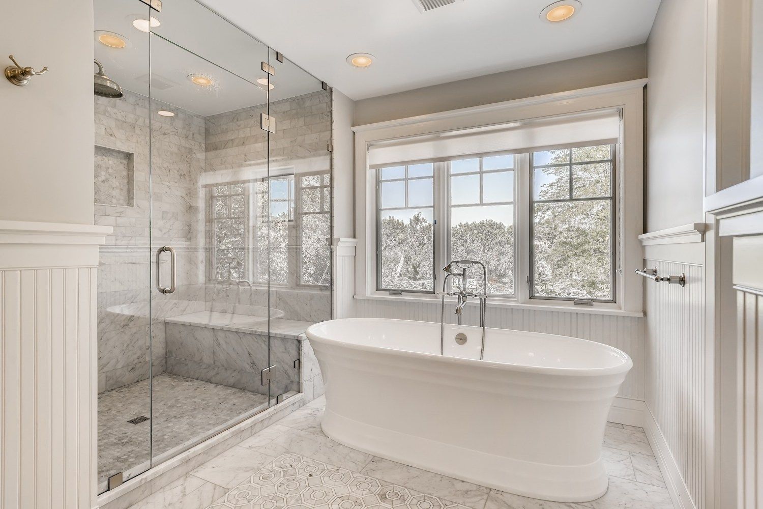 A bathroom with a tub, shower, and window.