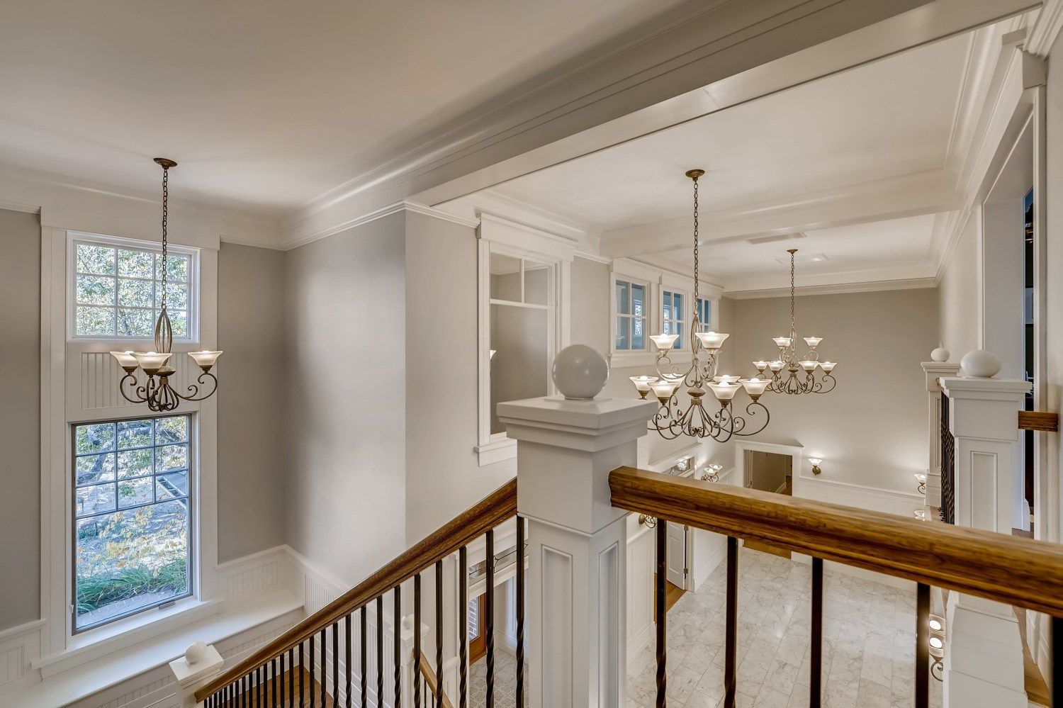 A view of a staircase from the second floor of a house.