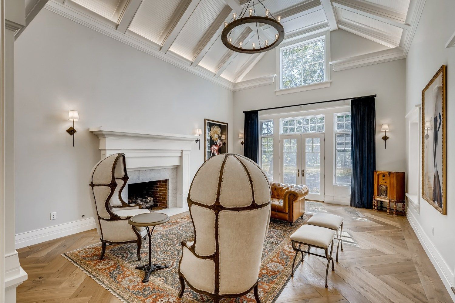 A living room with a couch, chairs, and a fireplace.
