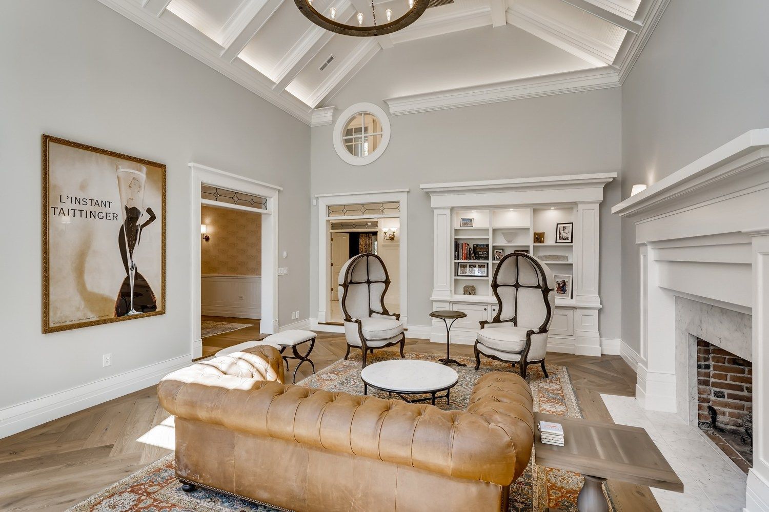 A living room with a couch, chairs, and a fireplace.