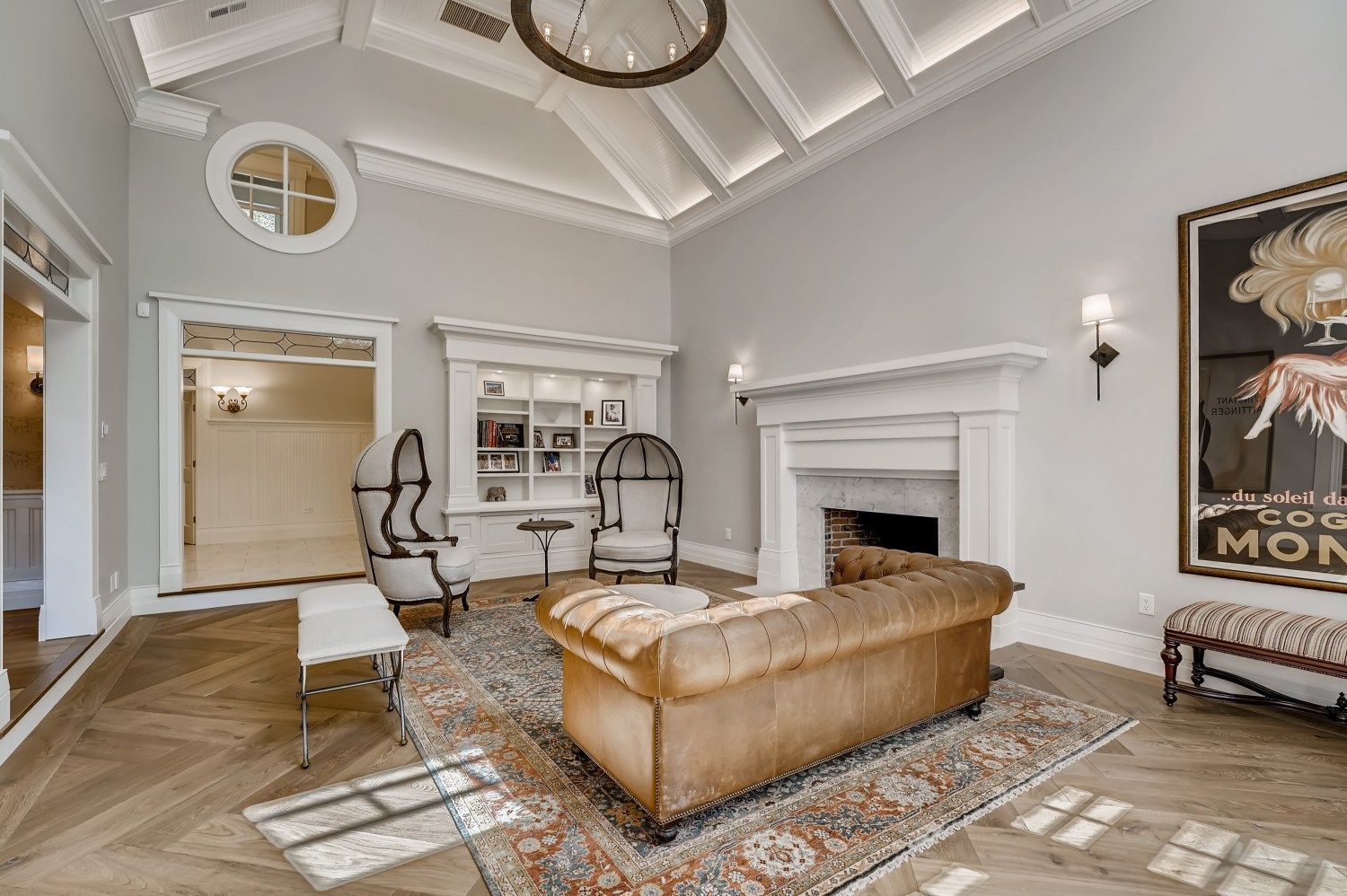 A living room with a couch, chairs, a fireplace, and a rug.
