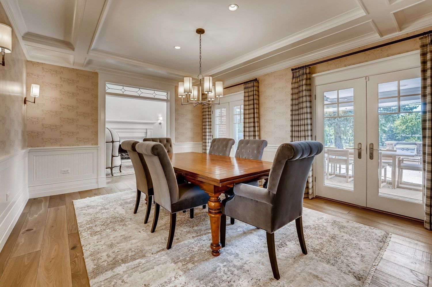 A dining room with a table and chairs and a chandelier.
