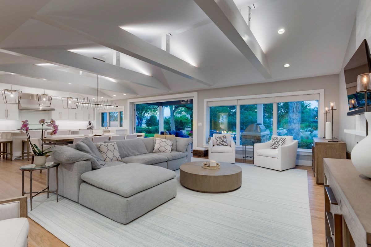 A living room with a large sectional couch, chairs, and a round coffee table.