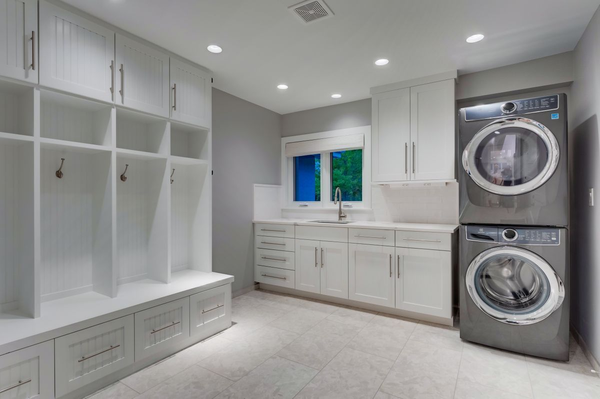 A laundry room with a washer and dryer stacked on top of each other.