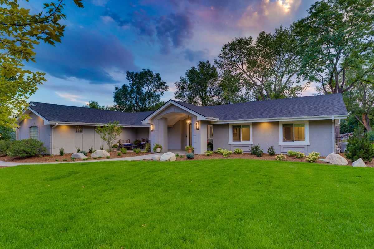 A house with a large lawn in front of it.