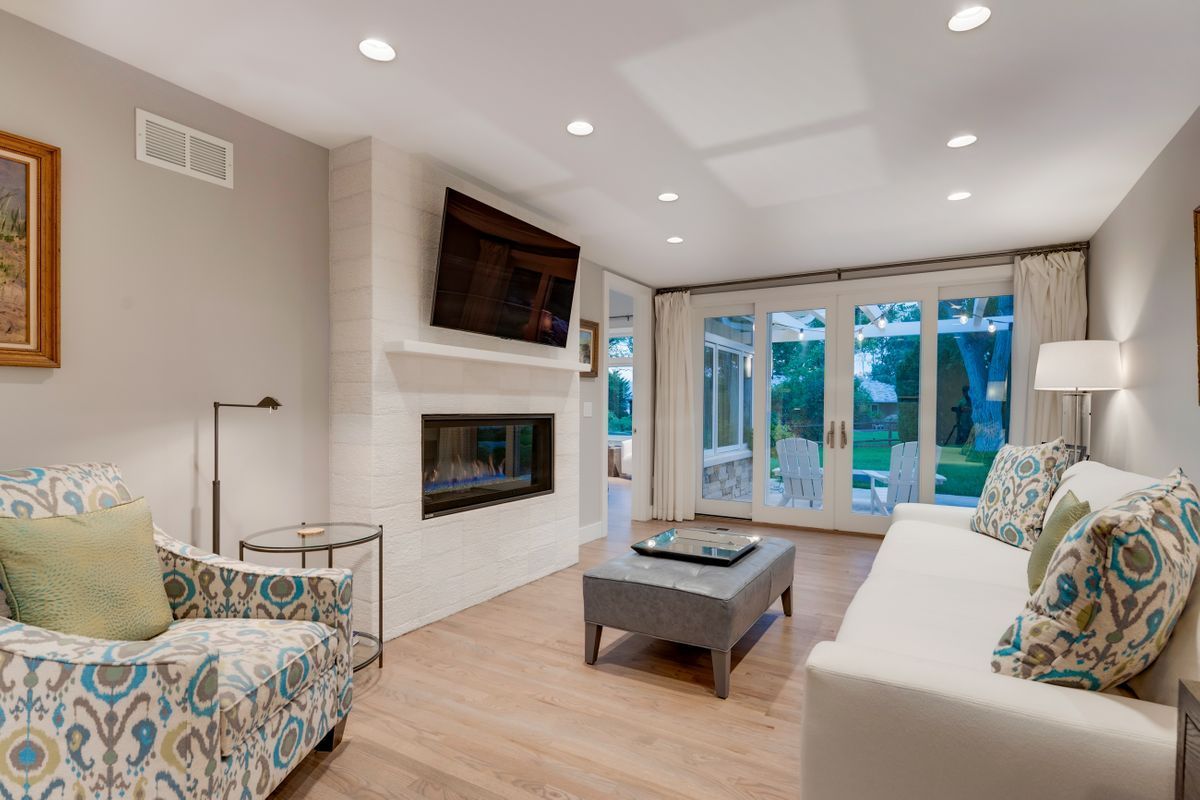 A living room with a couch, chair, coffee table, and television.