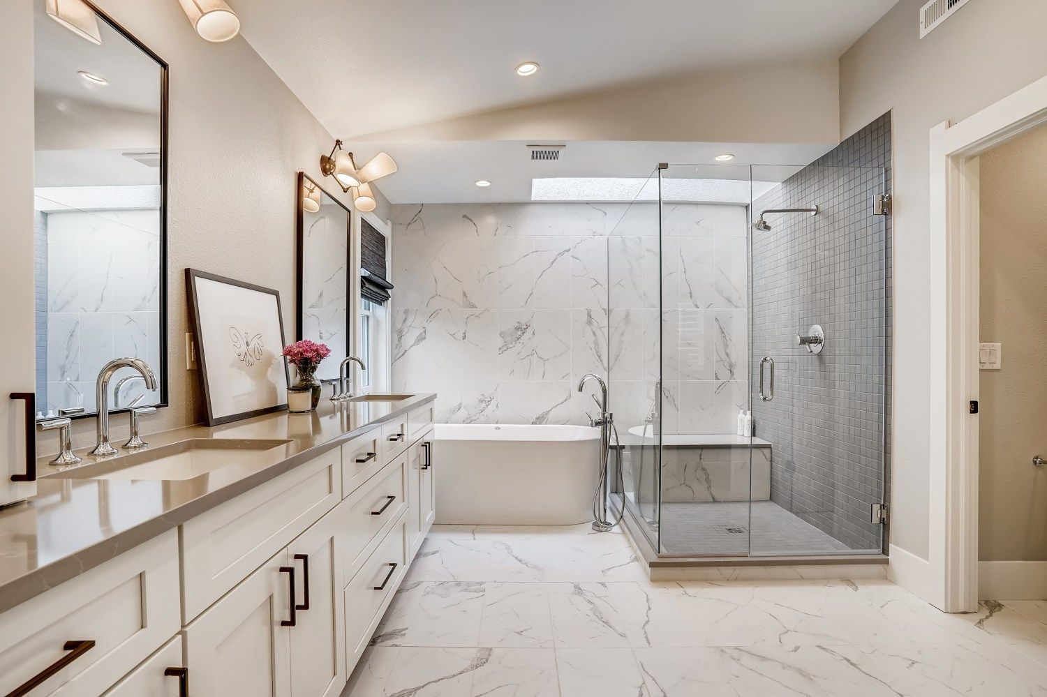 A bathroom with two sinks, a tub, and a walk in shower.