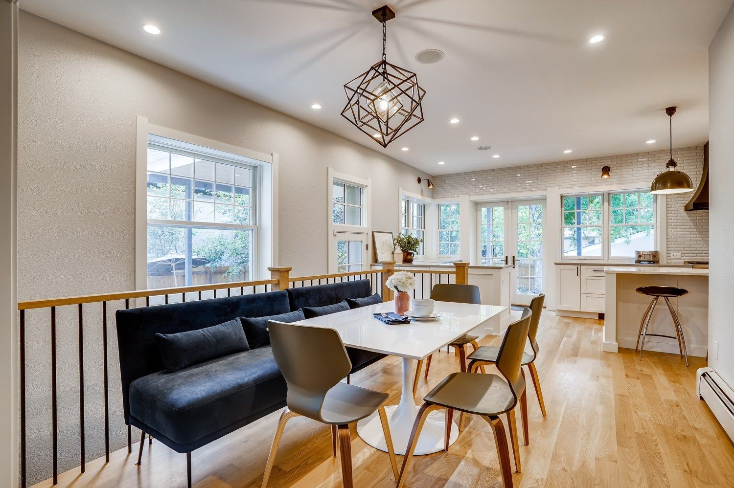 A dining room with a table and chairs and a bench.