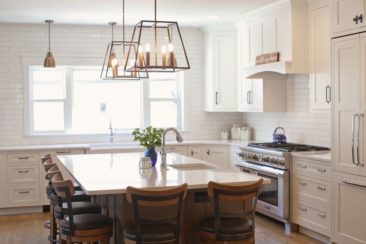 A white house with a large lawn in front of it.