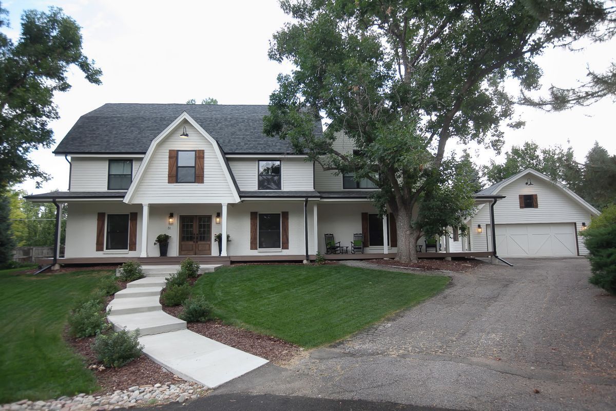 A large white house with a driveway leading to it