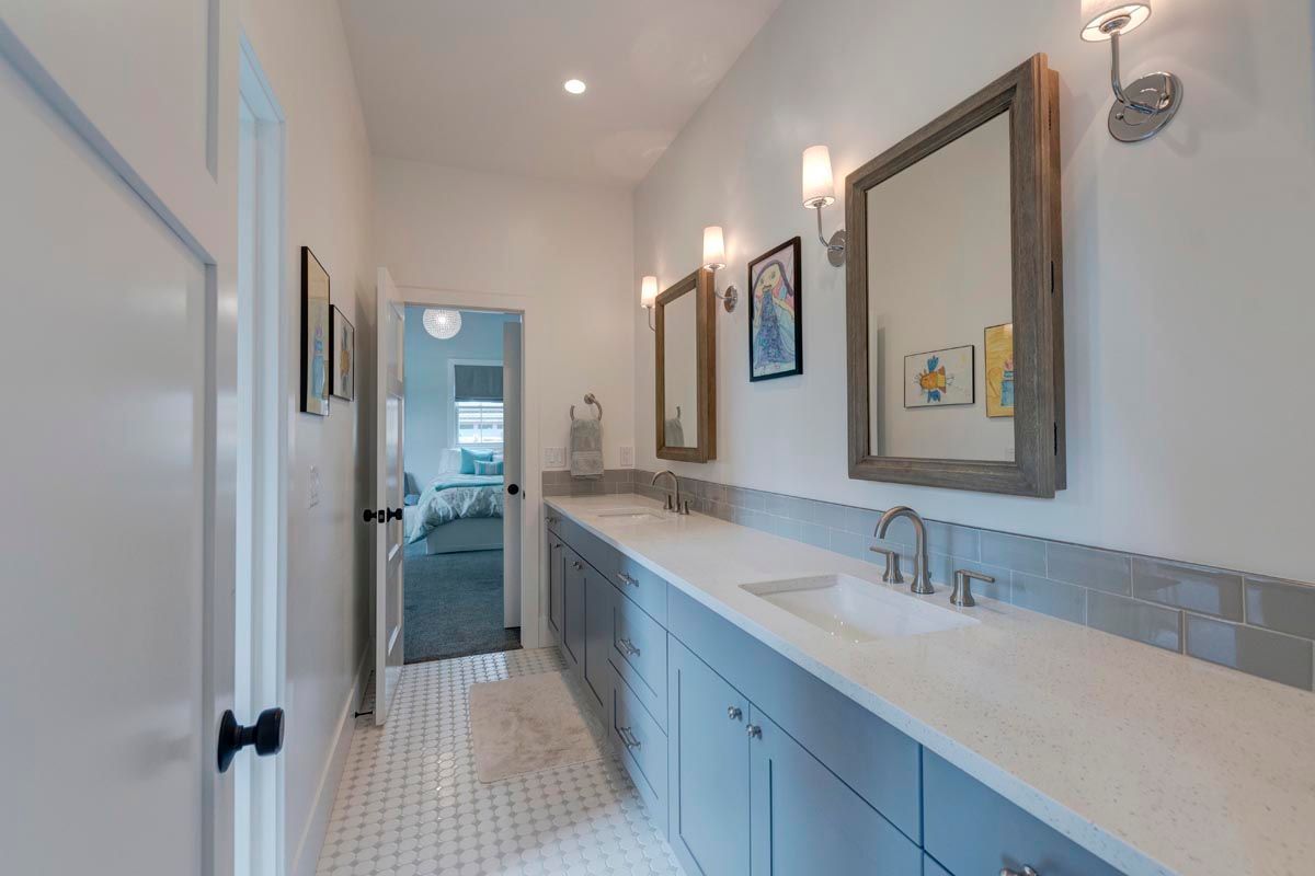 A bathroom with two sinks and two mirrors.