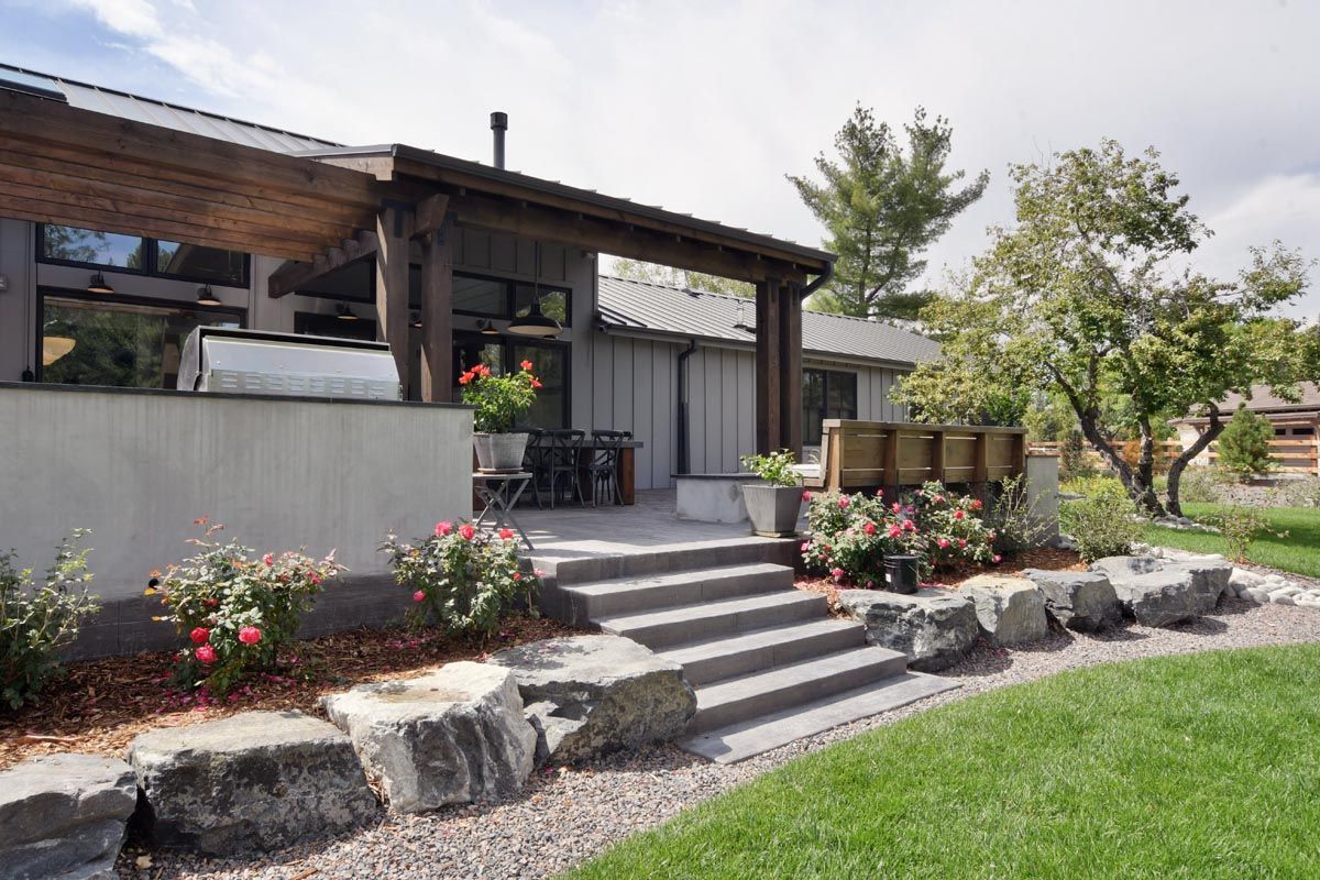 A house with a covered patio and stairs leading to it.