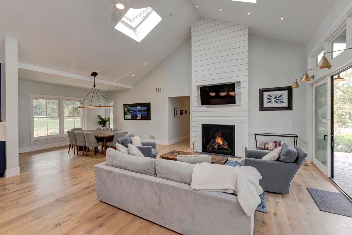 A living room with a couch, chairs, and a fireplace.