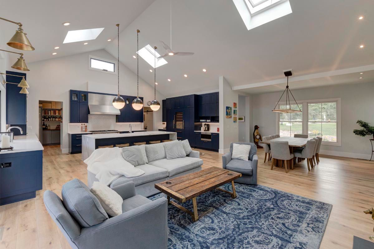 A living room with a couch, chairs, and a coffee table.
