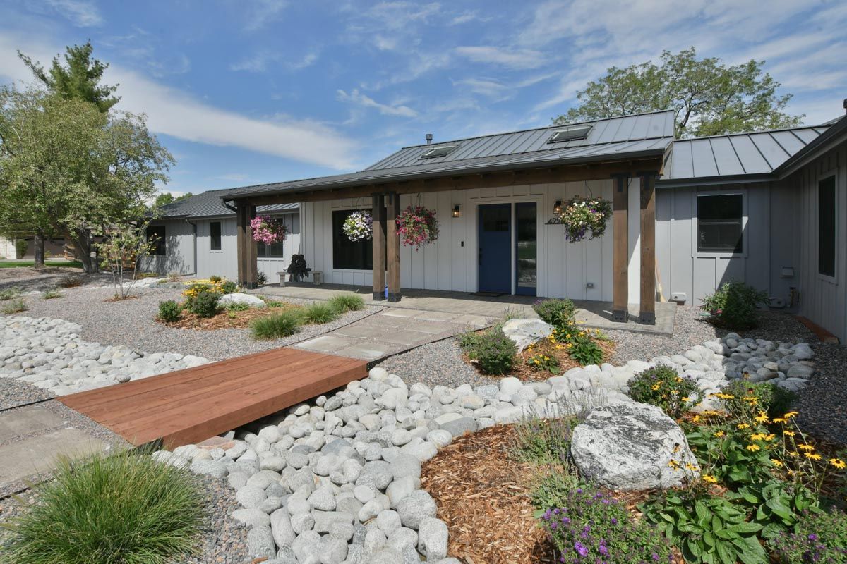 A house with a wooden bridge in front of it.