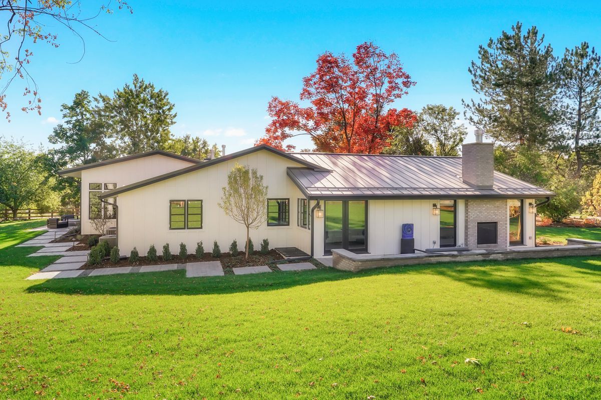 A white house with a large lawn in front of it
