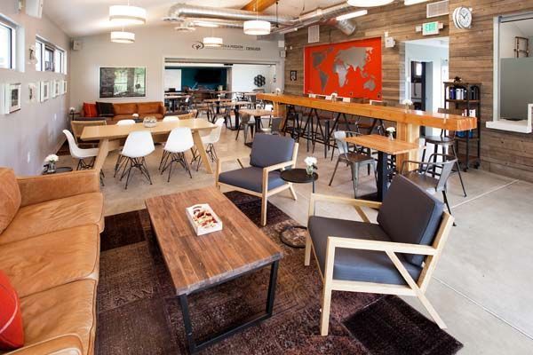 A living room with a couch, chairs, tables, and a coffee table.