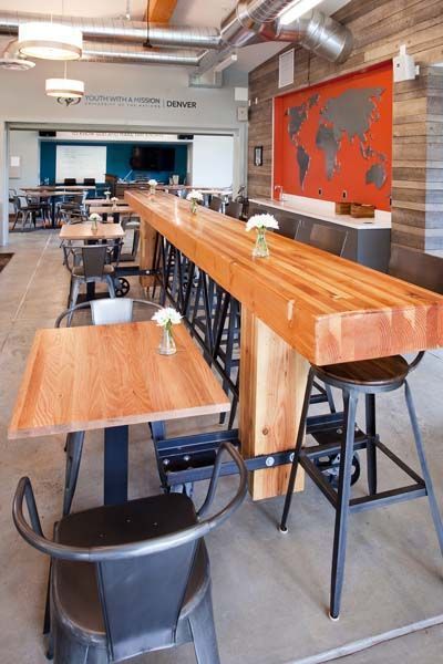 A restaurant with tables and chairs and a map on the wall.