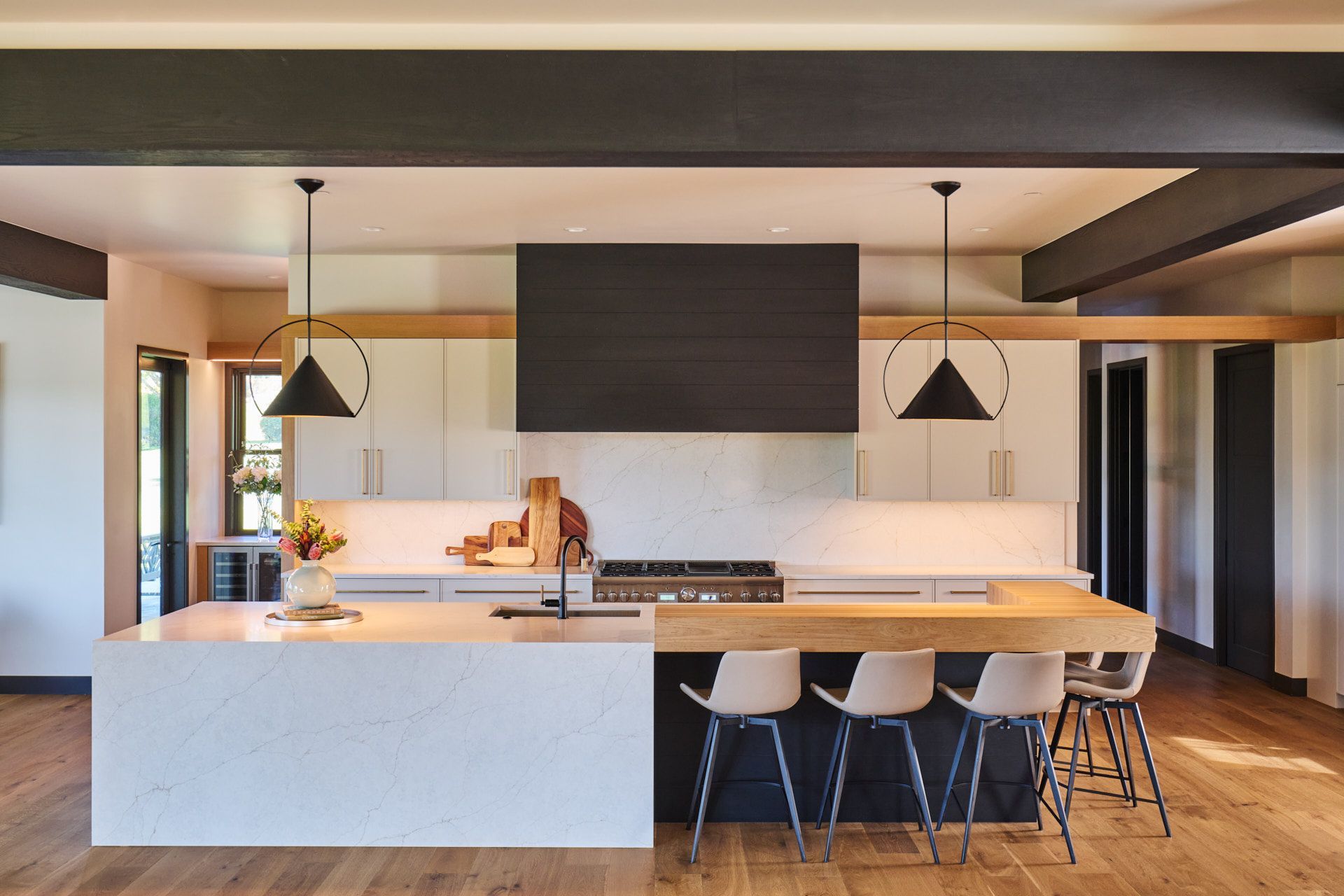 A kitchen with a large island and a stove top oven