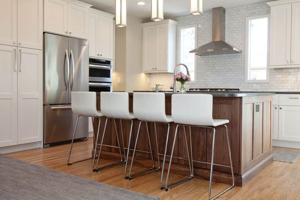 A kitchen with white cabinets and stainless steel appliances.