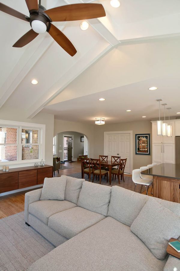 A living room with a couch and dining table.