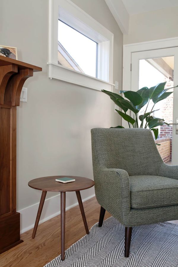 There is a chair and a table in the living room.