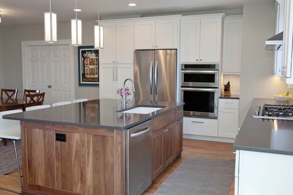 A kitchen with stainless steel appliances and wooden cabinets.