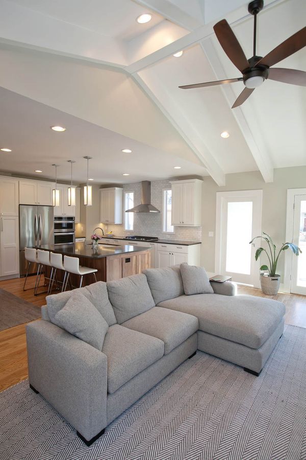 A living room with a couch and a ceiling fan.