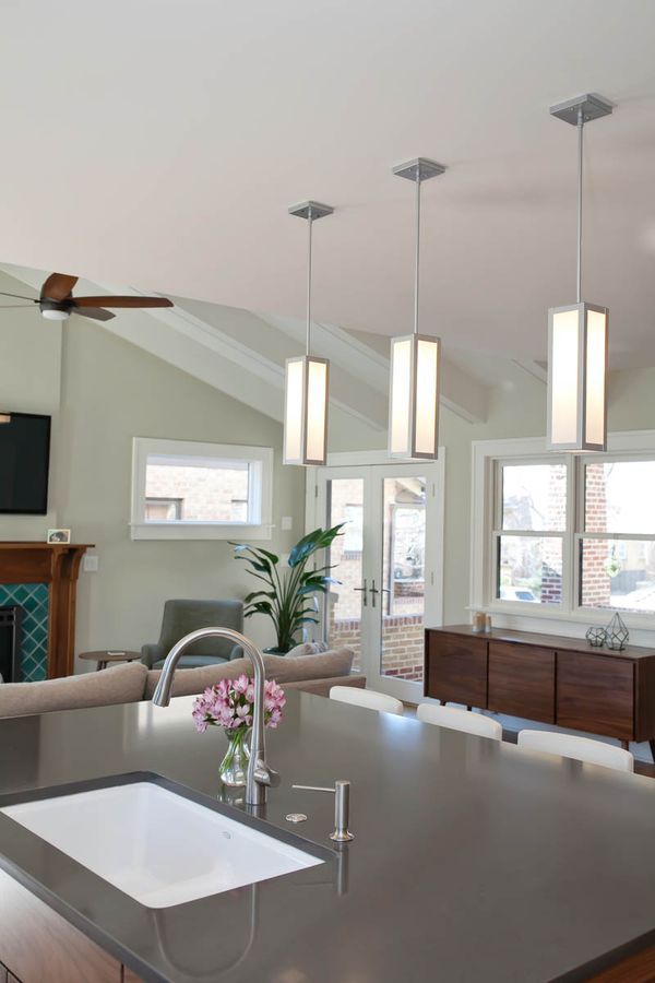 A kitchen with a sink and a ceiling fan.