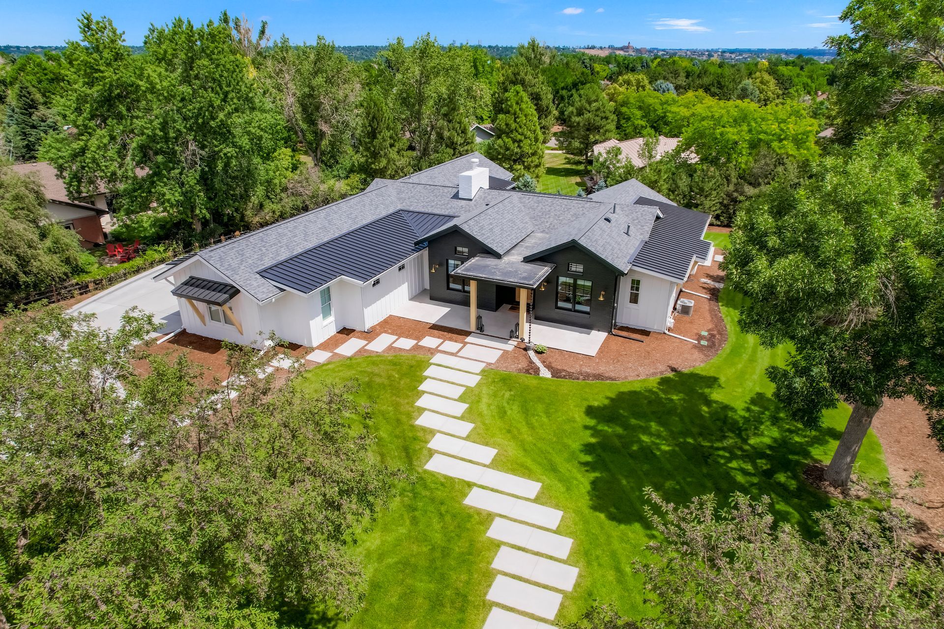 An aerial view of a large house surrounded by trees