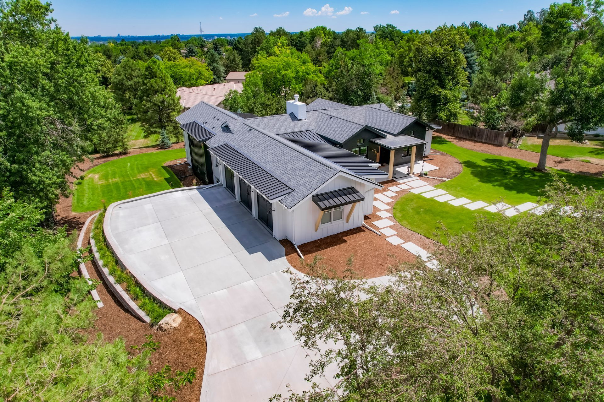 A large white house with a large lawn in front of it.