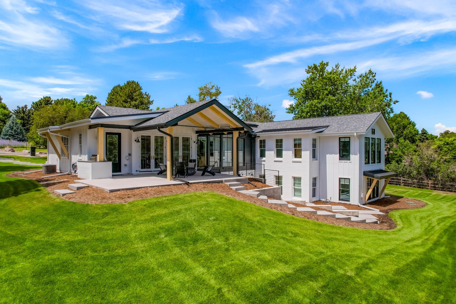 A large white house with a large lawn in front of it.