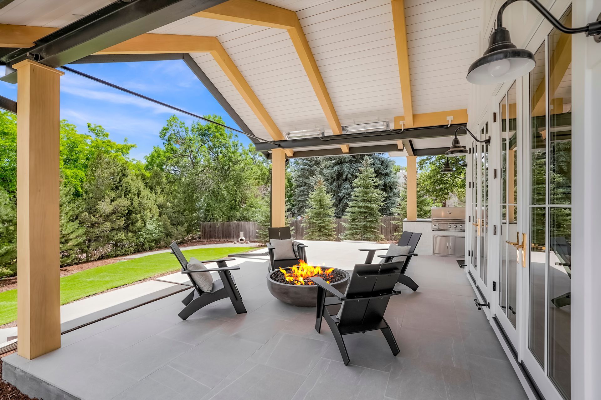 There is a fire pit on the patio of a house.