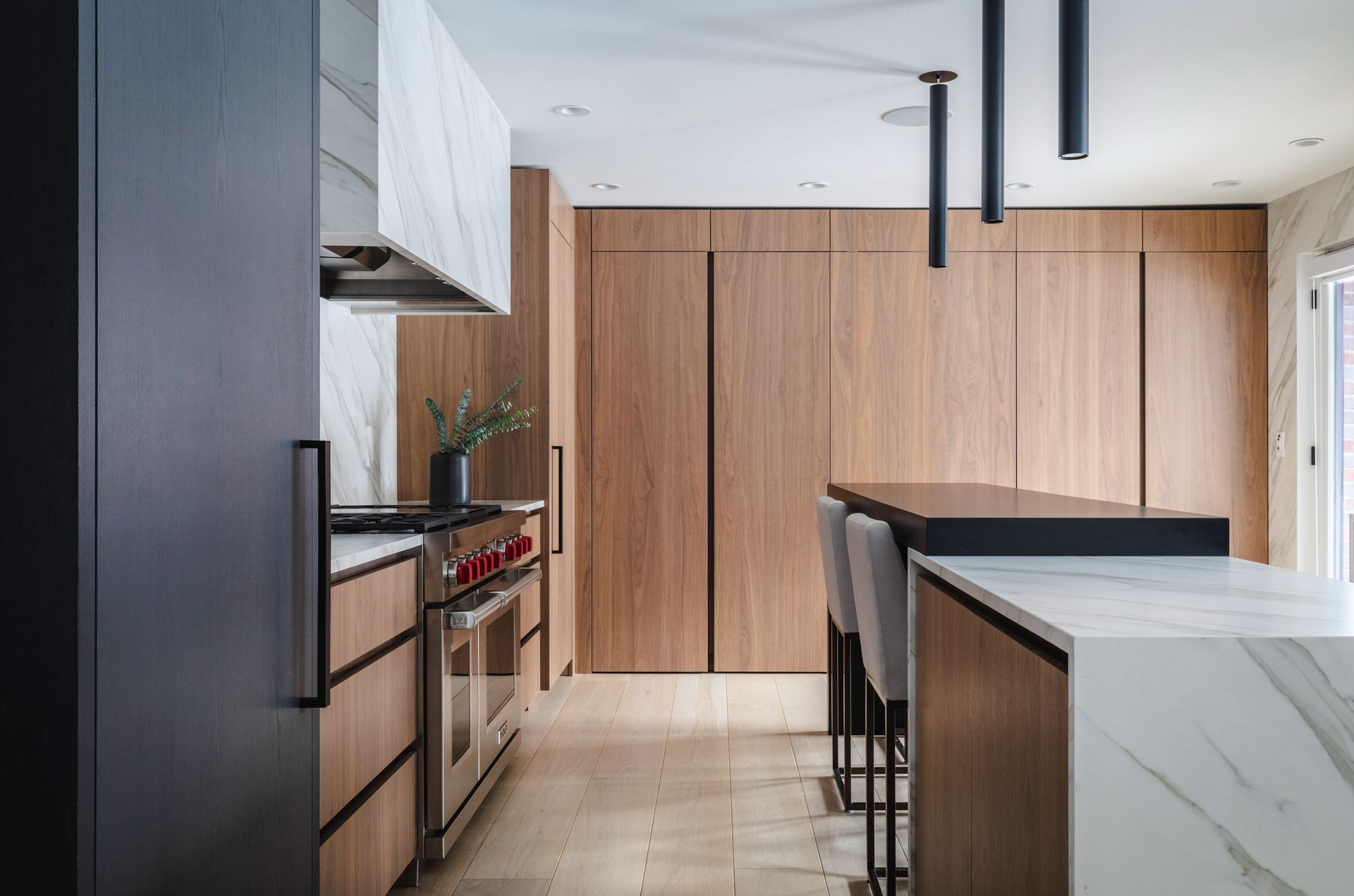 A kitchen with wooden cabinets , stainless steel appliances , and a large island.