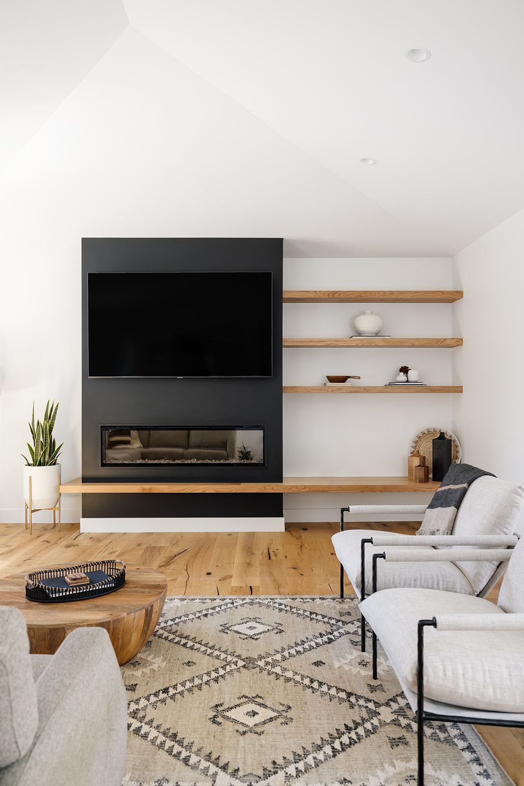 A living room with a fireplace and a flat screen tv.