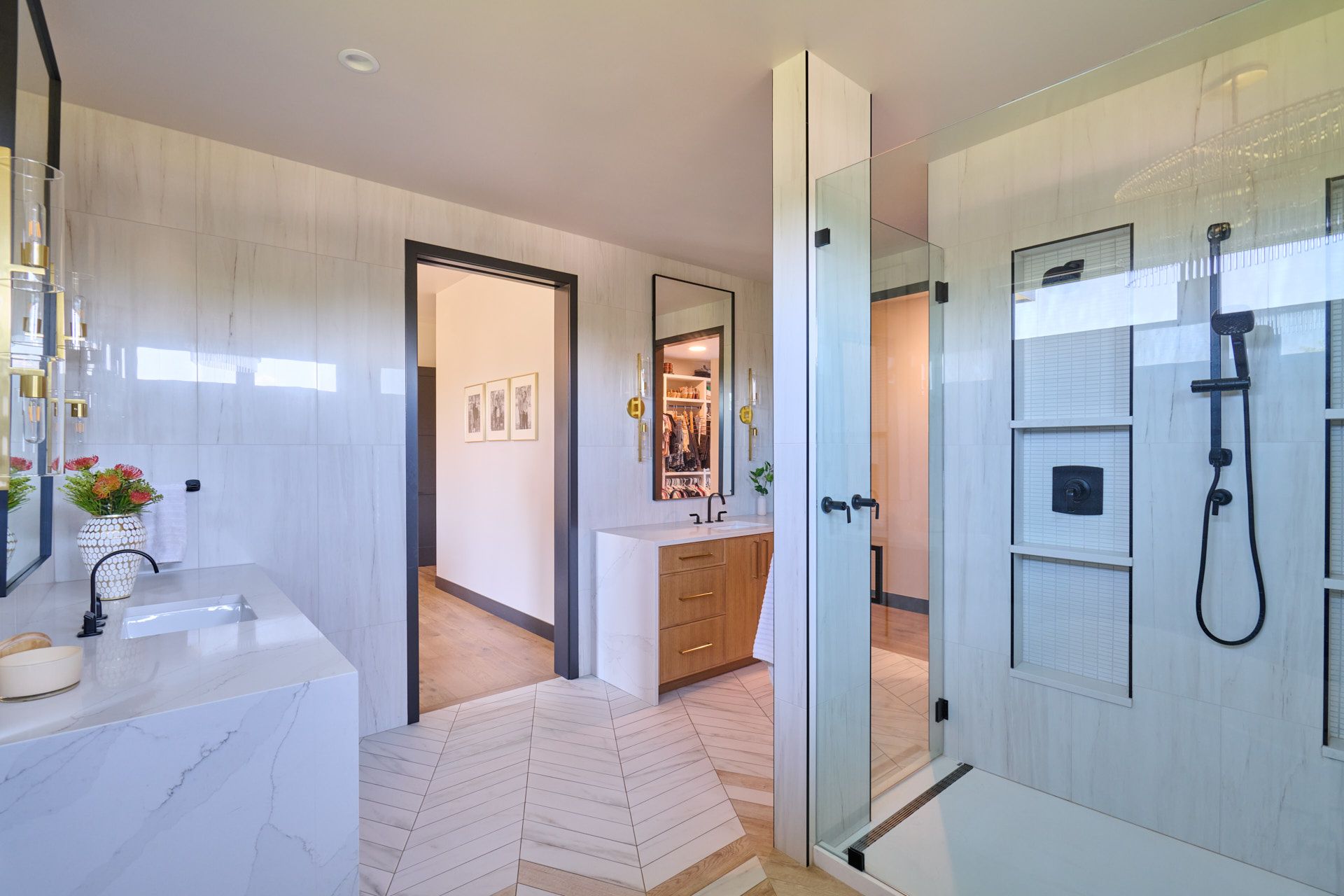 A bathroom with a walk in shower, sink and mirror.