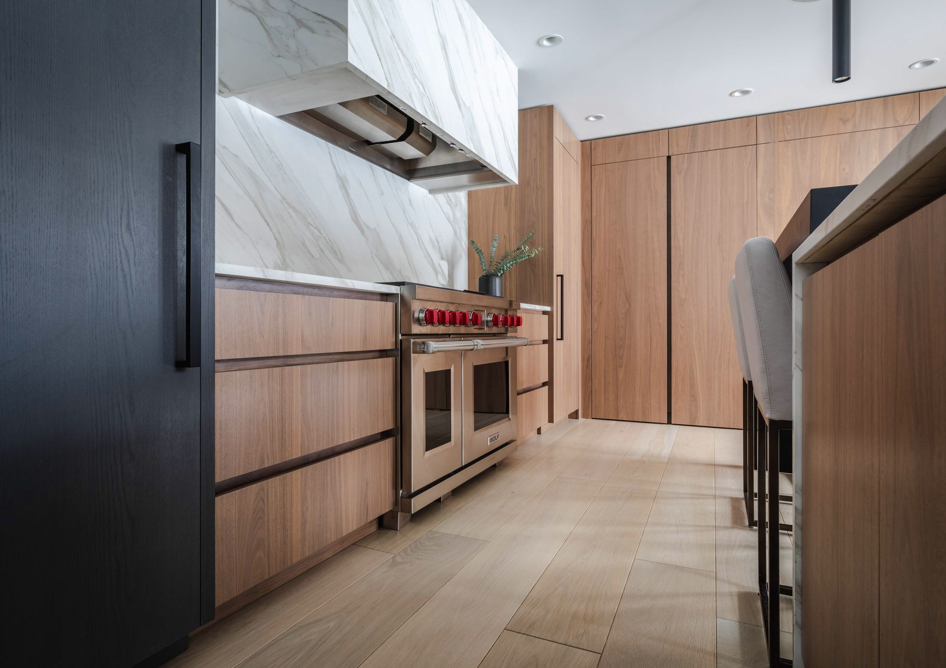 A kitchen with wooden cabinets , a stove , and a refrigerator.