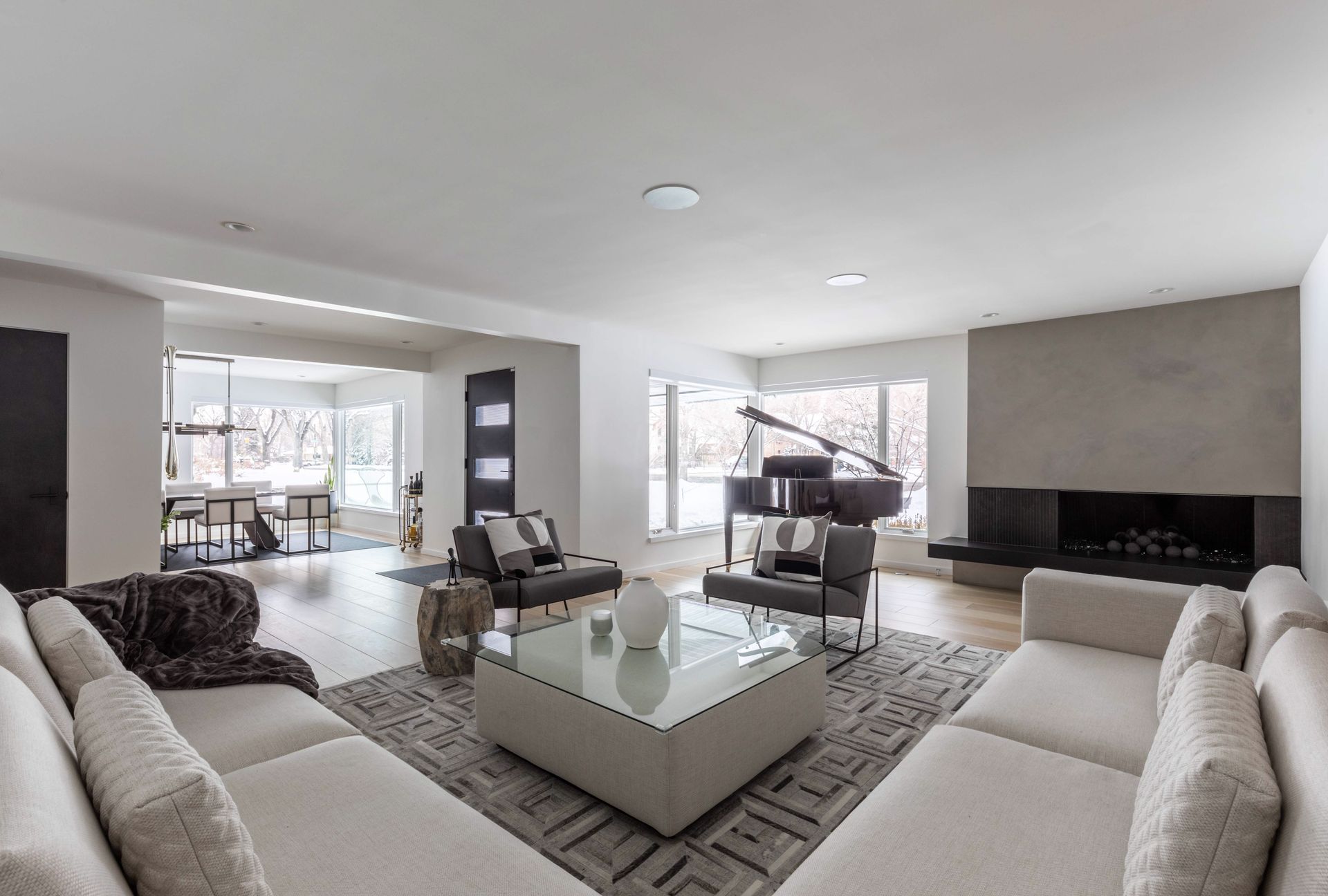 A living room filled with furniture and a piano.