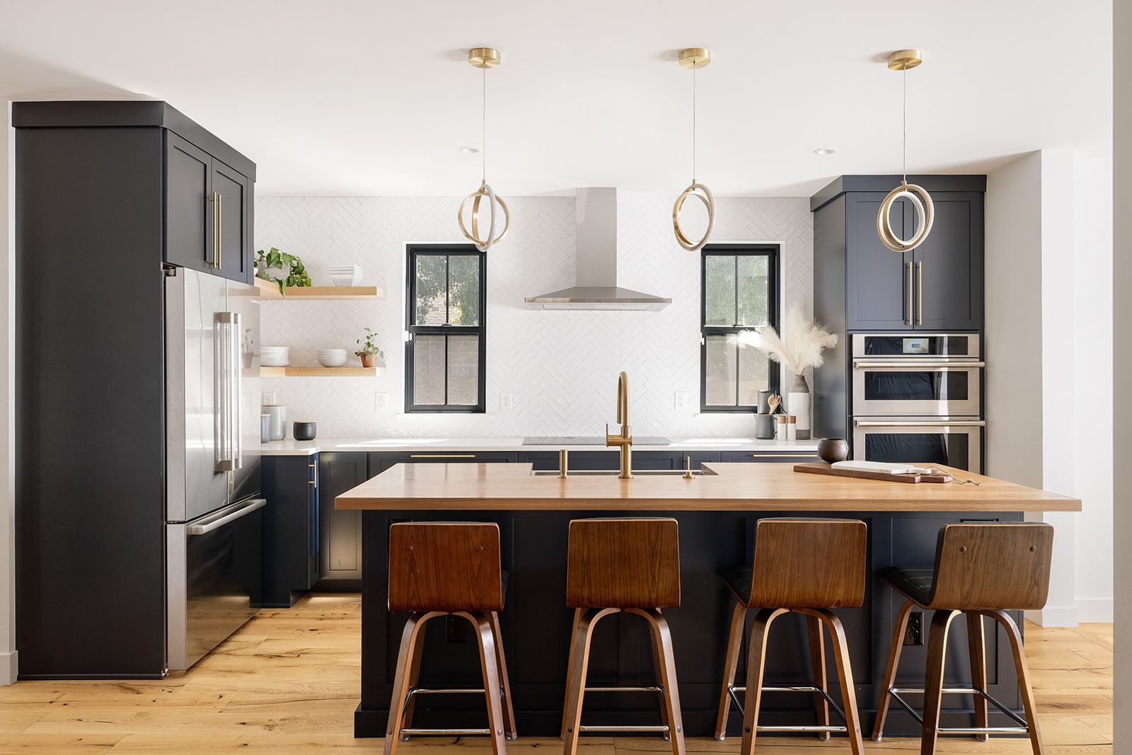 A kitchen with a large island and stools