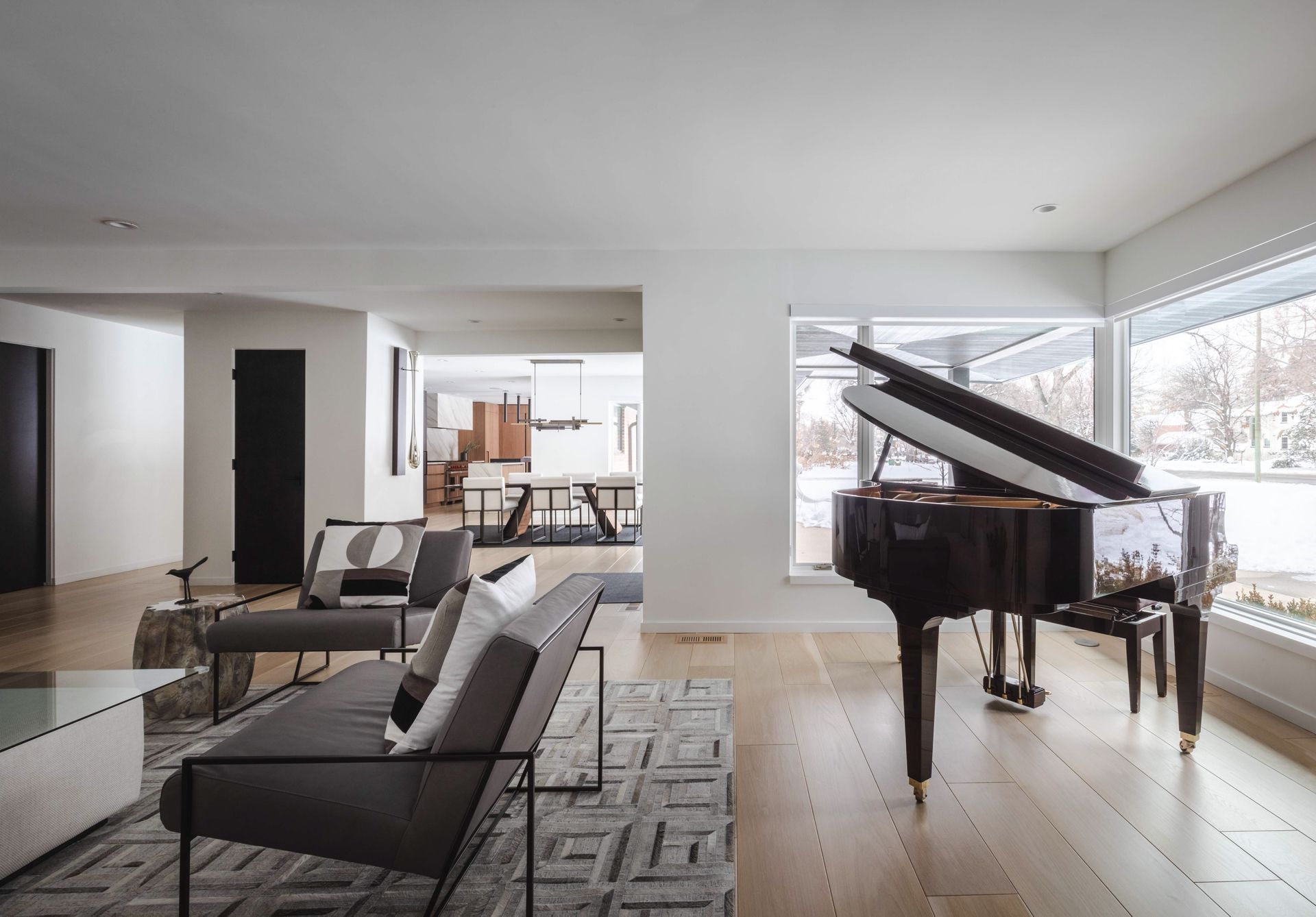 There is a piano in the middle of the living room.